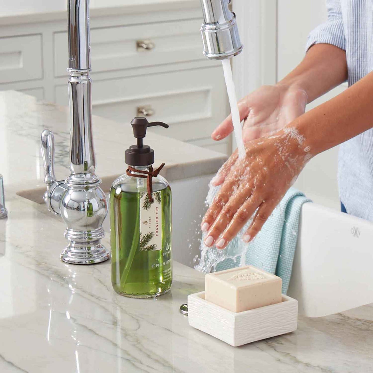 Woman washing hands with Thymes Frasier for Large Hand Wash