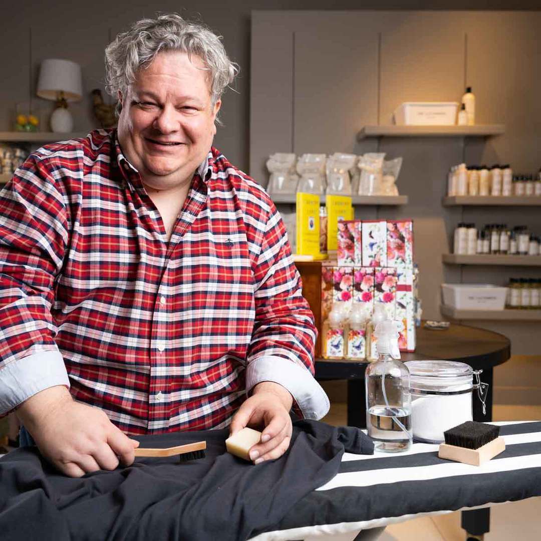Patric removing stains on a ironing board