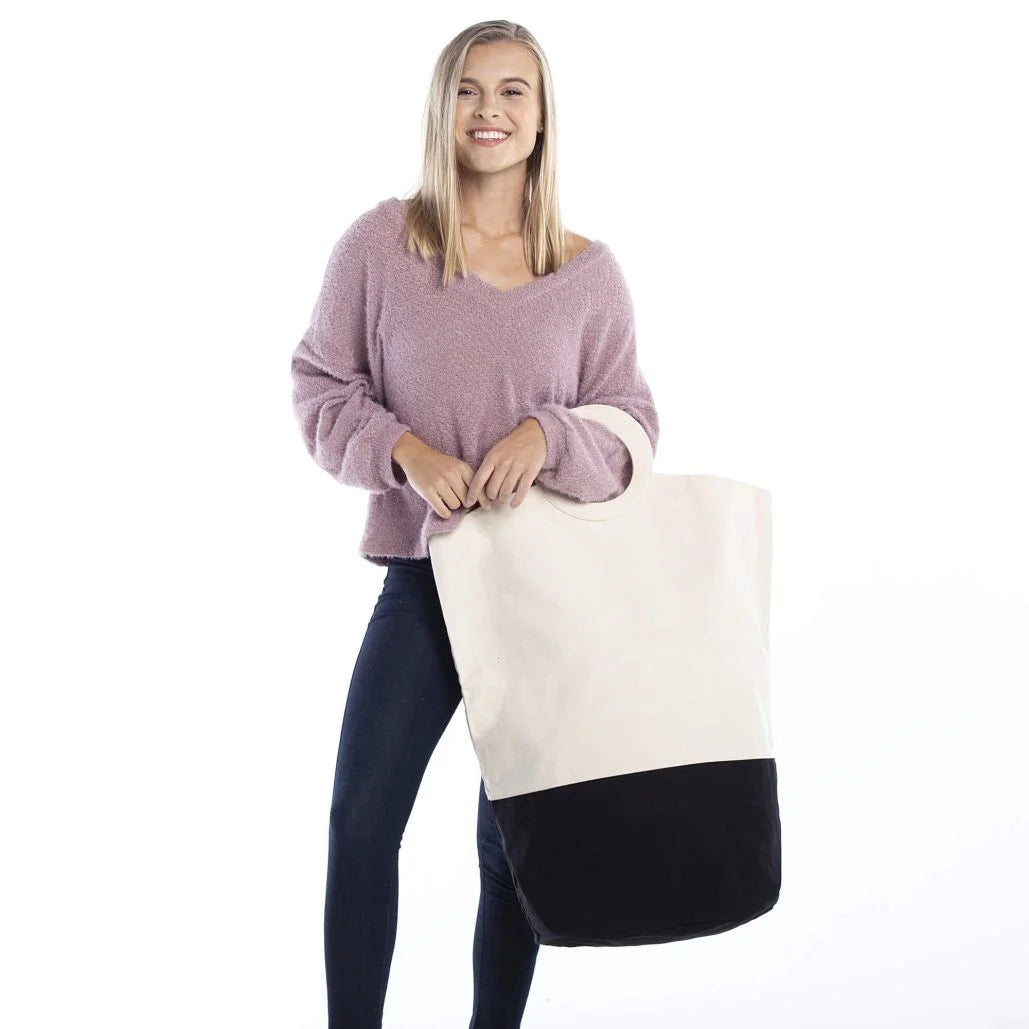 Woman holding canvas laundry hamper