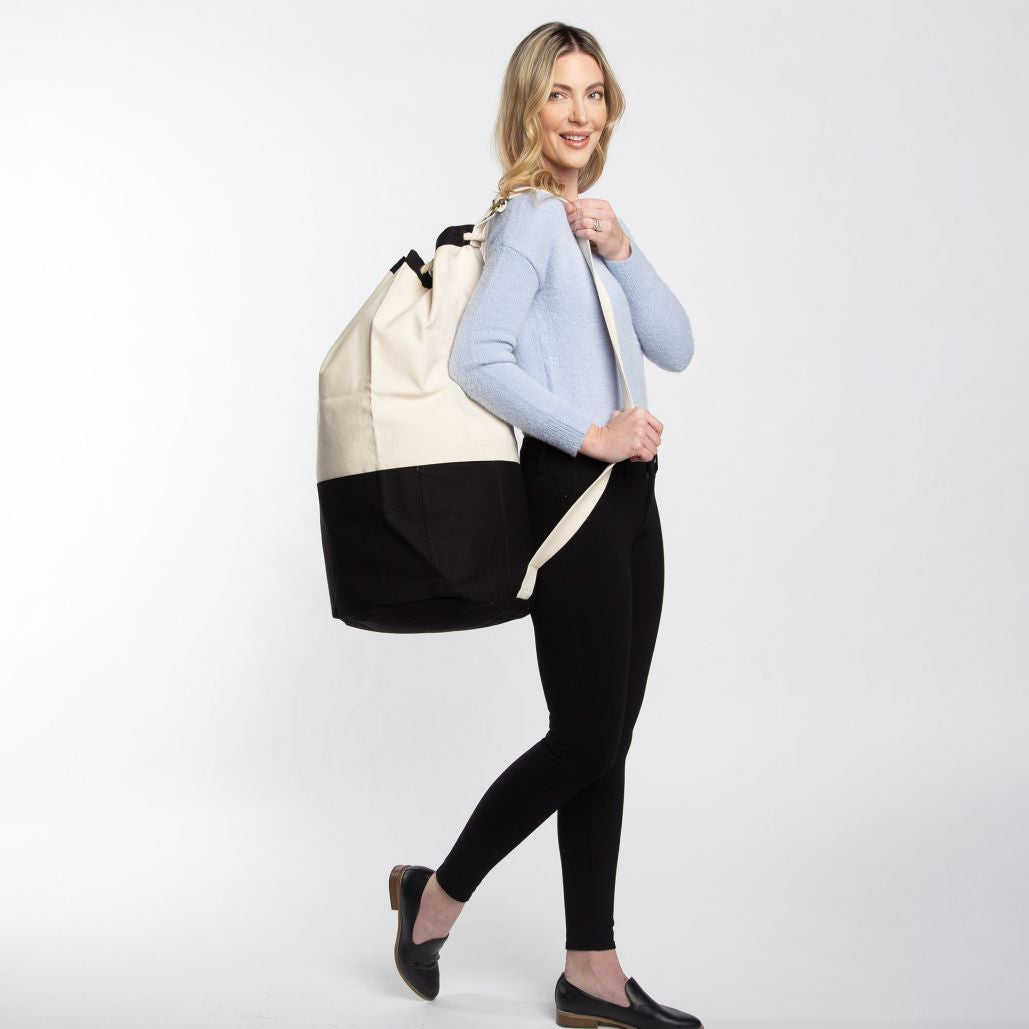 Woman carrying laundry duffel 