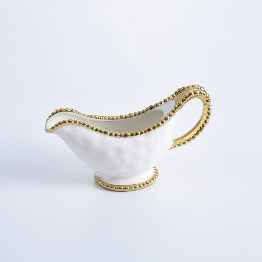 gold and white gravy boat