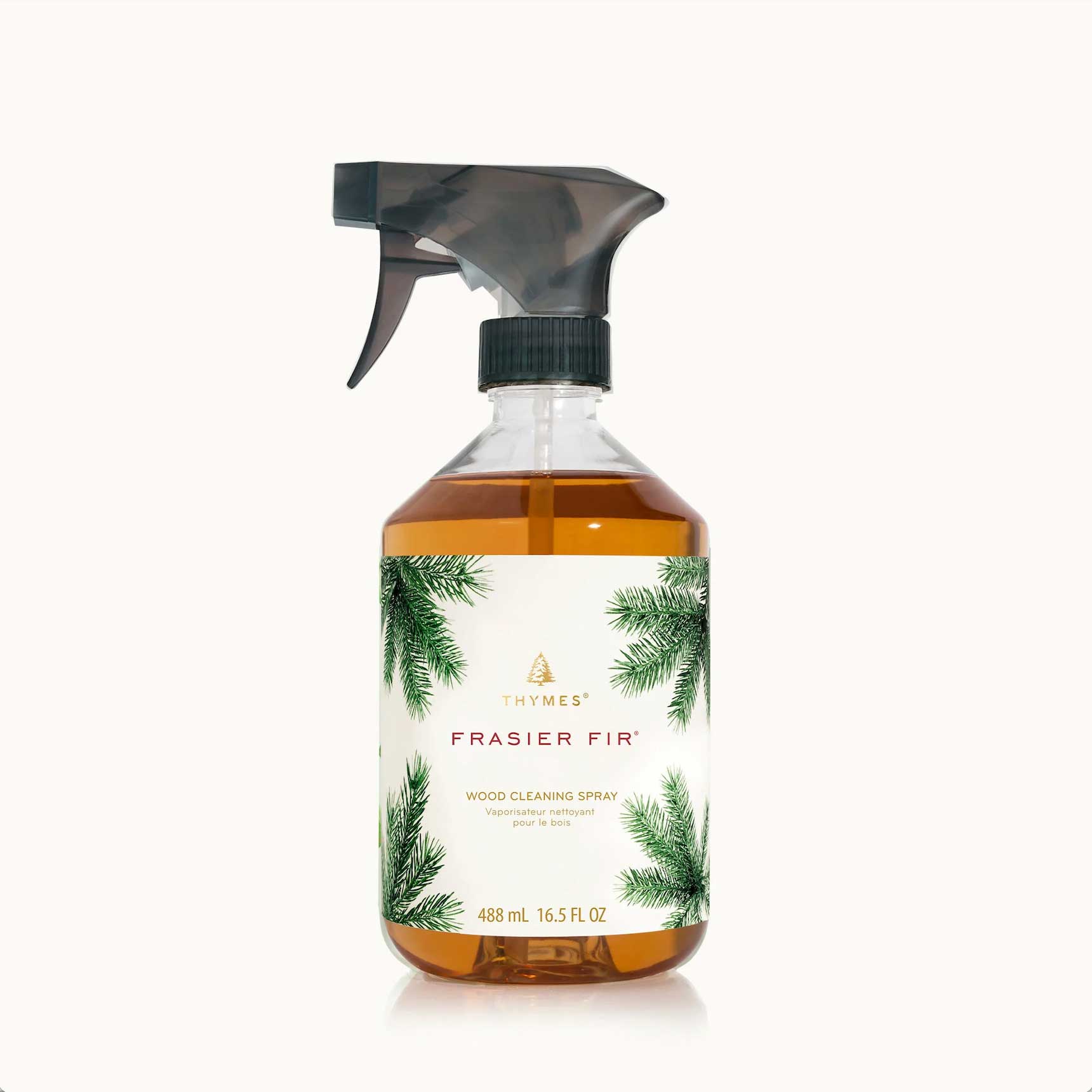 Thymes Frasier Fir Wood Cleaning Spray on Countertop image number 1 Woman using Thymes Frasier Fir Wood Cleaning Spray image number 2 Basket of Thymes Frasier Fir Home Care Products image number 3 Frasier Fir Wood Cleaning Spray